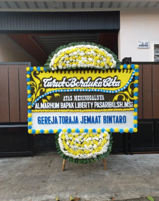 Papan Bunga Duka di Wapoga